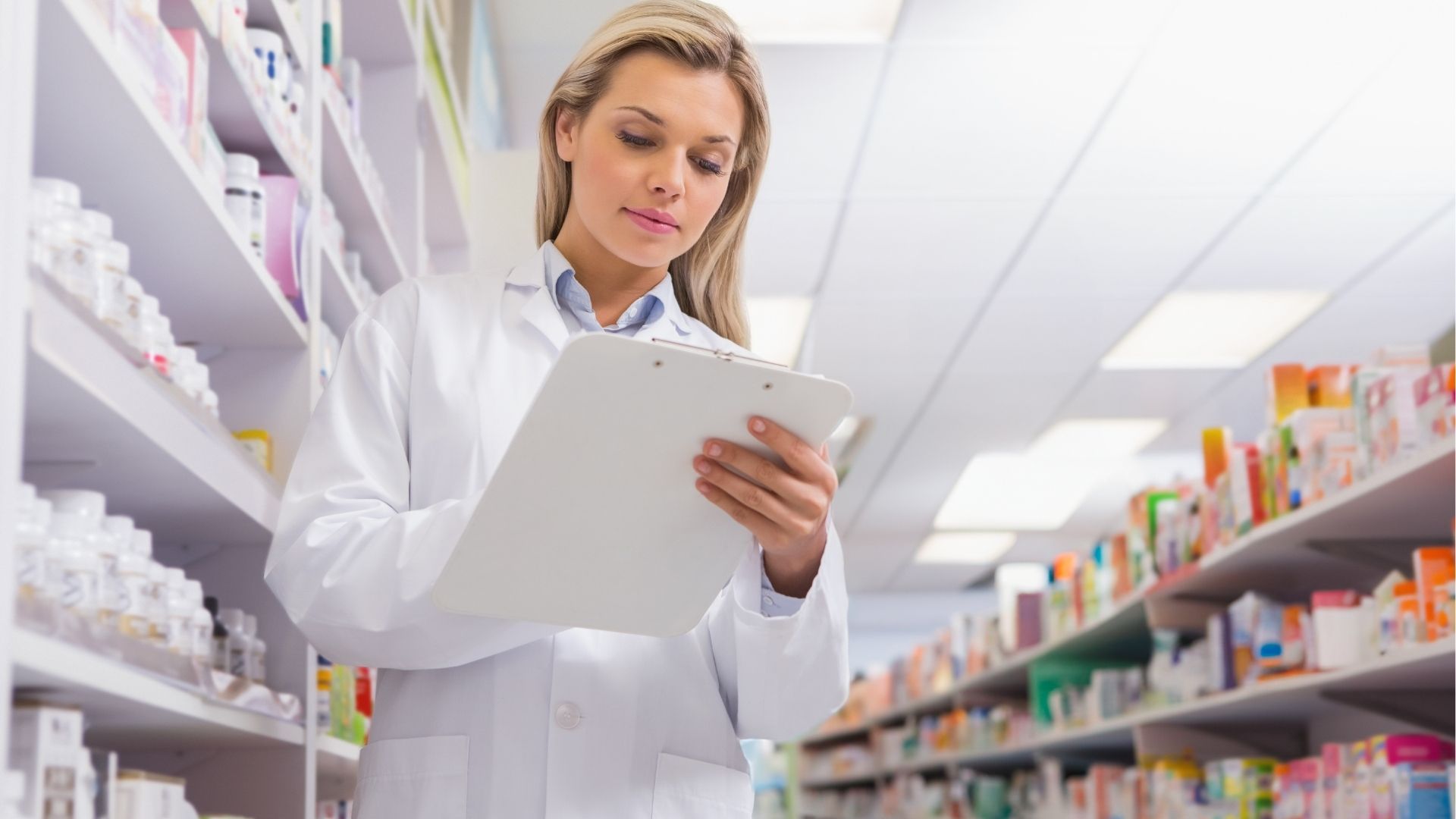 Pharmacienne vérifiant un registre dans une pharmacie